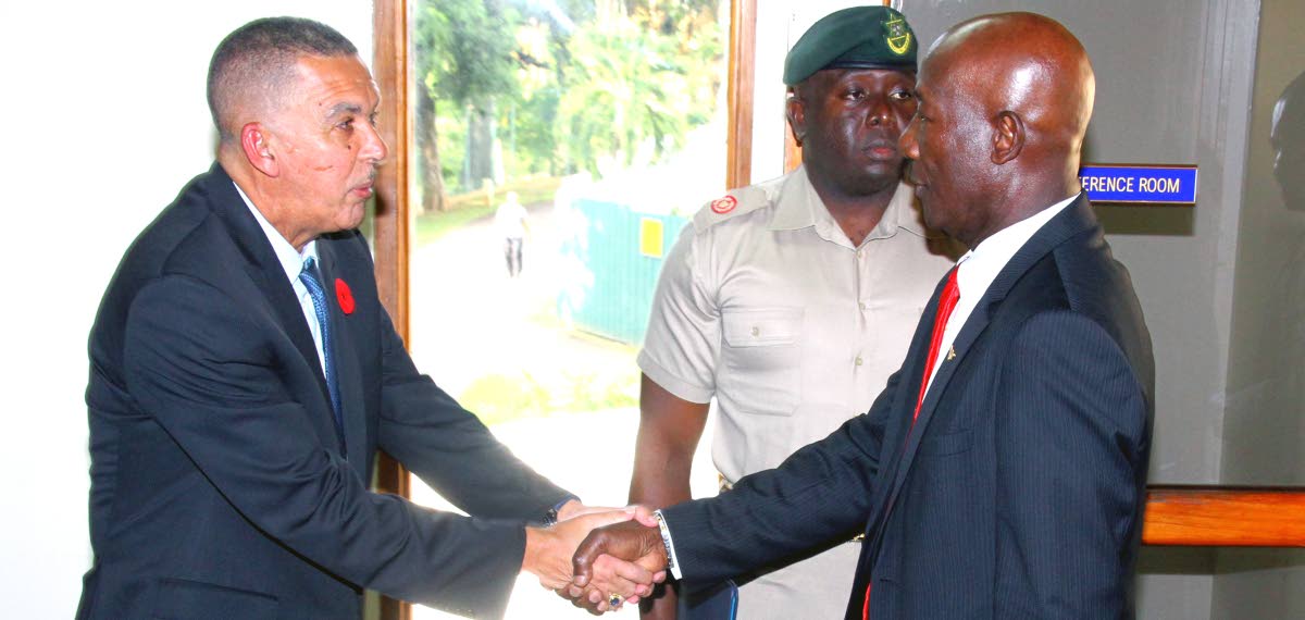 FRIENDLY SHAKE: President Anthony Carmona, left, shakes hands with Prime Minister Dr Keith Rowley.