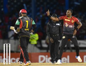 Trinbago Knight Riders captain Dwayne Bravo dances as he celebrates the dismissal of St Kitts and Nevis Patriots batsman Mohammed Nabi (left) during their August 14 meeting at the Queen’s Park Oval. PHOTO COURTESY CPLT20.COM