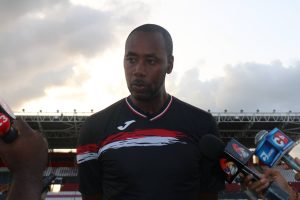 National coach Dennis Lawrence speaks to the media yesterday ahead of today’s friendly international against Jamaica at the Hasely Crawford Stadium, Mucurapo.