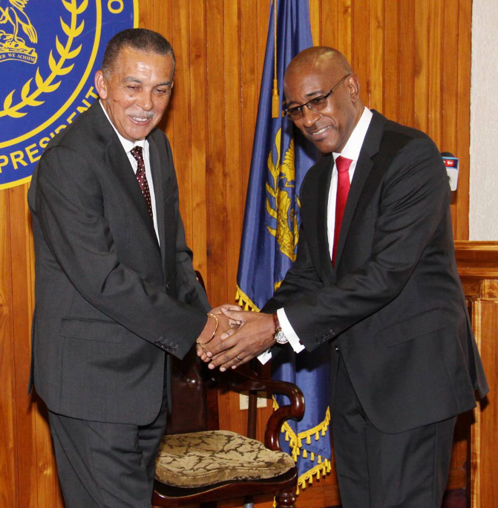 President Anthony Carmona, congratulates Robert Le Hunte, after he was sworn in as the Minister of Public Utilities, President House, St. Anns, just days ago.