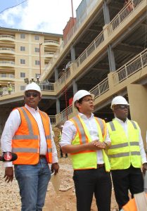 Housing Minister Randall Mitchell flank  by HDC Chairman Newman George  right and Managing Director Brent Lyons left as they tours the HDC  Vieux Fort Housing Development in St James , 137 apartments units in four buildings will soon be available here.25-08-17 PHOTO SUREASH CHOLAI