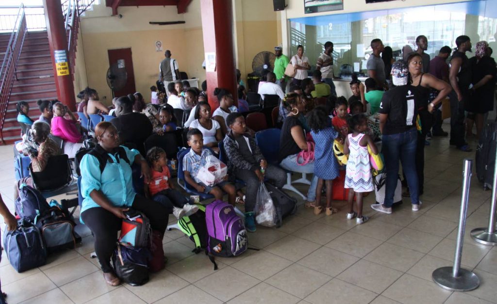 Passengers endure a long wait at the Tobago ferry terminal in Port of Spain.