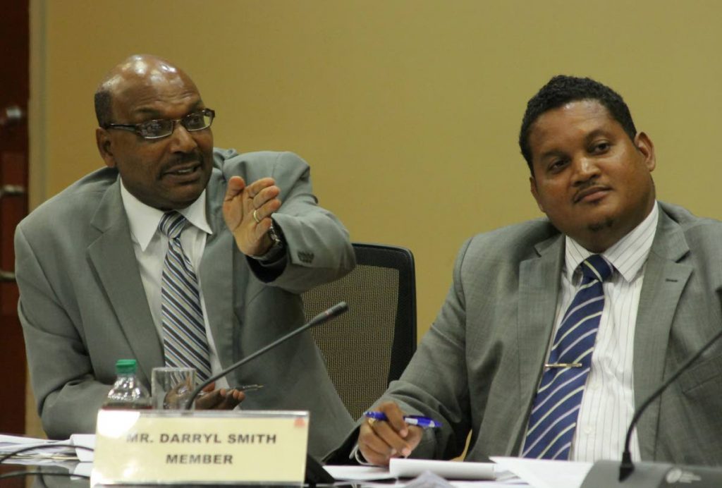 On the same side: Opposition Senator Wade Mark, left, and Sports Minister Darryl Smith as members of the Land and Physical Infrastructure JSC when the committee met the PTSC board in June. File photo