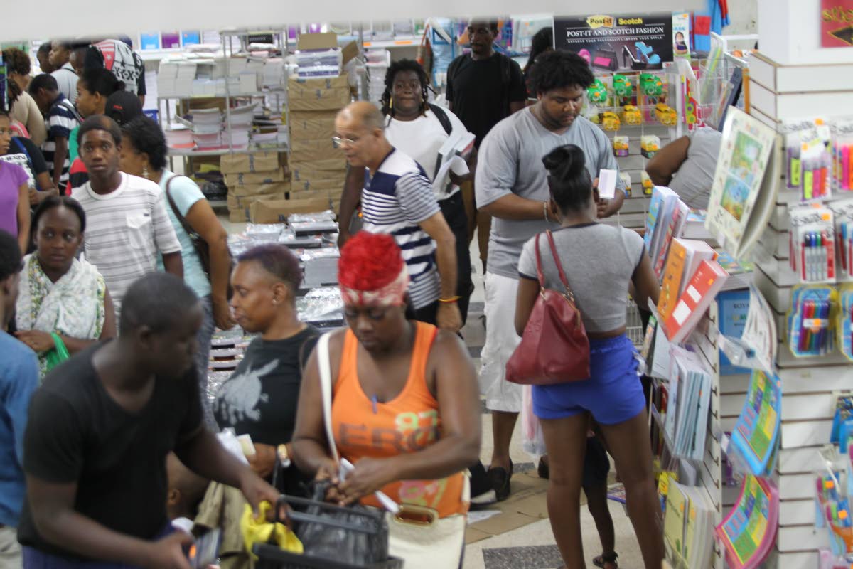 Rush to buy: Customers buy school supplies at Ishmael M Khan and Sons Ltd, Henry Street, Port of Spain yesterday before schools reopen tomorrow. Photo by Rattan Jadoo