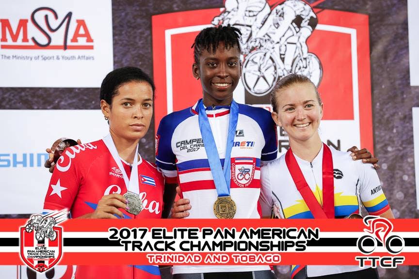 Trinidad and Tobago’s Teneil Campbell, centre, poses with her gold medal on Friday night at the Elite Pan Am Cycling Championships held at the National Cycling Centre, Couva.