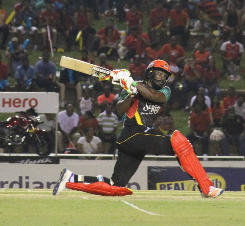 Chris Gayle of the St Kitts and Nevis Patriots sweeps during his unbeaten knock of 54 against the Trinbago Knight Riders at the Brian Lara Cricket Academy, Tarouba on Tuesday.