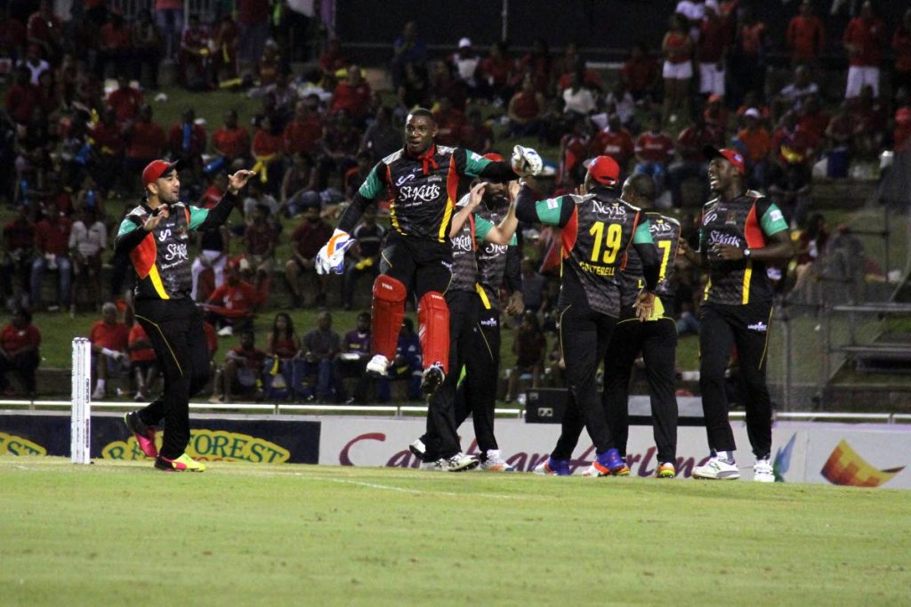 St Kitts/Nevis Patroits wicketkeeper Devon Thomas (second from left) leaps in delight after the dismissal of a Trinbago Knight Riders batsman on Tuesday night.
