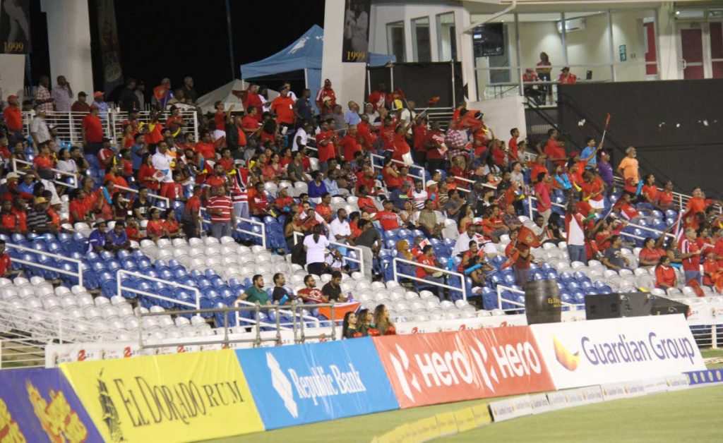 Fans in a semi-filled stand make noise during the Trinbago Knight Riders vs St Kitts and Nevis Patriots match on Tuesday at the Brian Lara Academy, Tarouba.