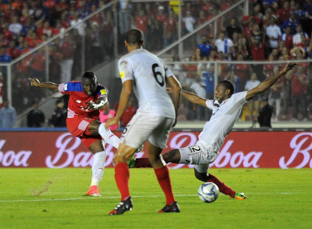 Panama’s Abdiel Arroyo, left, shoots at goal as Trinidad and Tobago’s Carlyle Mitchell, right, looks to block in a 2018 World Cup qualifier in Panama City, Tuesday.