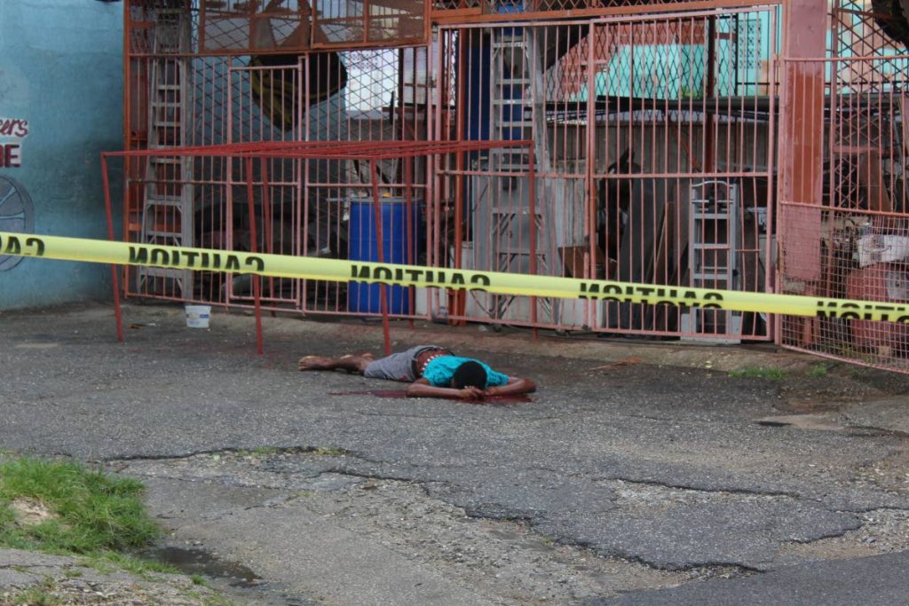 Unidentified man shot and killed yesterday outside the Trinidad Freelancers Pan Groove Steel Orchestra panyard on Duncan Street. 
