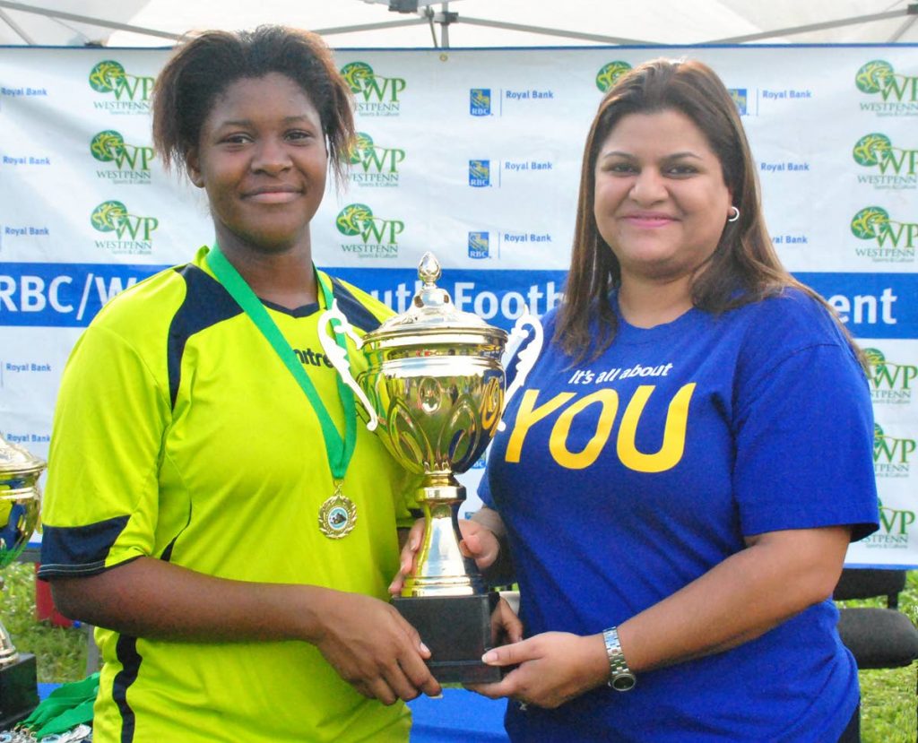 Nadya Maharaj, right, RBC Branch Manager, West Mall, presents the RBC West Penn Girls Under-18 “Big 4” knockout trophy to Akilah Crawford, captain of champions Diego Martin Central United FC, following the final against St. James Youth FC at Diego Martin North Secondary School on Sunday.