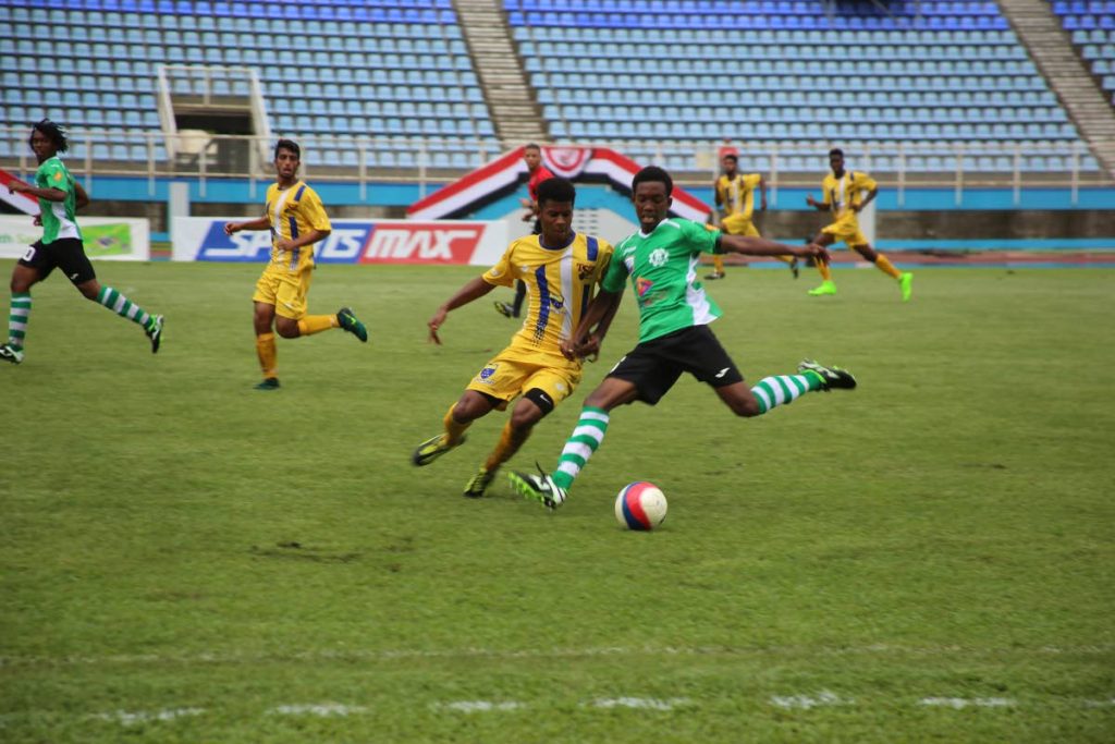 Carapichaima’s Josiah King (right) holds off Fatima’s Isaiah Lamont (left) during the opening match of the SSFL at the Ato Boldon Stadium, Couva, yesterday.