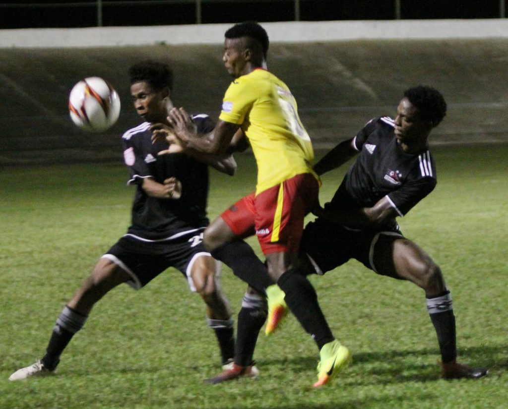 REMATCH: North East Stars Kevon Villaroel, centre, is sandwiched by Central FC’s Kaydion Gabriel, right, and Jules Lee, in their previous clash at the Arima Velodrome, yesterday.