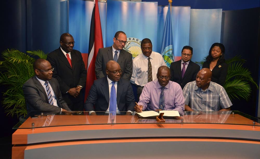 THA Chief Administrator Raye Sandy, second from right, front row, signs the memorandum of agreement between the Tobago House of Assembly, Mt Pleasant Credit Union and the Water and Sewerage Authority. Others in photo are, from left, front row, WASA Chairman, Romney Thomas, THA Chief Secretary, Kelvin Charles and Mt Pleasant Credit Unions President, Winford James while at back row, from left, are WASA CEO, Dr Ellis Burris, WASA Deputy Chairman, Richard Jones, THA Senior Legal Consultant, Alvin Pascal, WASA General Counsel and Corporate Secretary, Dion Abdool and Mt Pleasant Credit Union attorney, Giselle Sampson.