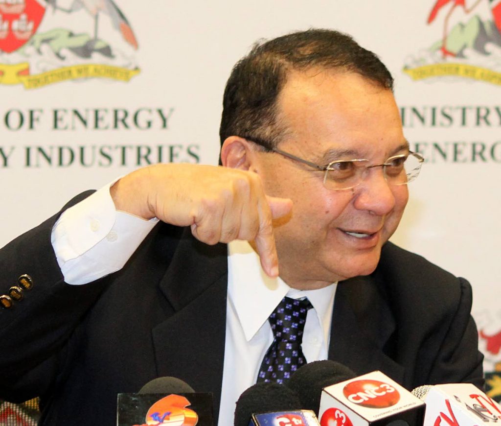 Minister of Energy and Energy Industries, Franklin Khan, indicates with the use of his finger, how the amount of oil delivered by operators to Petrotrin is measured using a 
