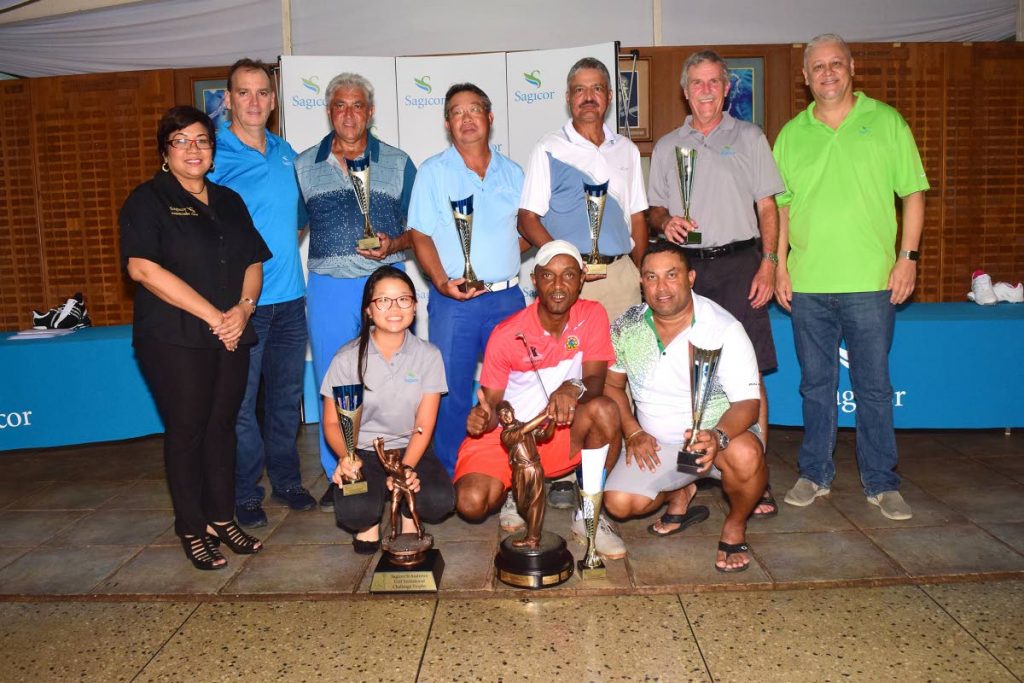 GROUP WINNERS: The Sagicor management team flanks the winners of the seven flights of the two-day Sagicor-St Andrews Invitational Golf Tournament held on Sunday, in Moka.
