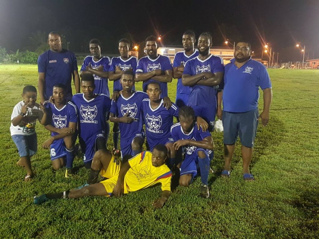 Dream Team players, coach and fans celebrate their victory on Tuesday in the Caribbean Welders Fishing Pond Football League.