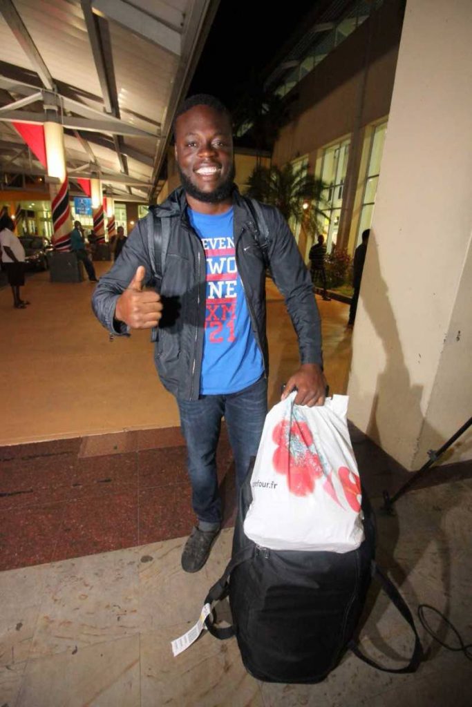 HOME SWEET HOME: University of the Southern Caribbean student Timothy Teito gives the thumbs up last night at Piarco International Airport shortly after he and other Trinis arrived from Antigua, having all survived Hurricane Irma when they were in the neighbouring island of St Martin last week. PHOTO BY ROGER JACOB