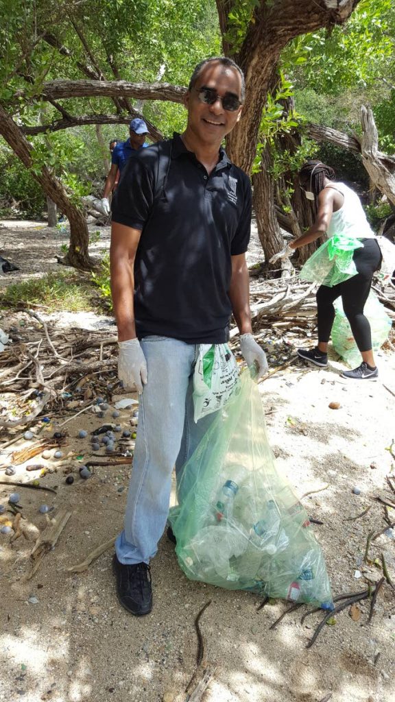 EMA director John Julien collecting plastic bottles and containers at Chacachacare Island during the 2017 International Coastal Cleanup yesterday. PHOTO BY JANELLE DE SOUZA