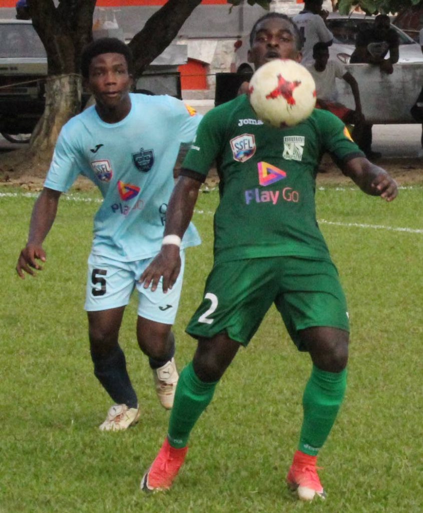 San Juan North’s T’shad Selvon, right, chests the ball as QRC’s Keon 
McPherso looks on at QRC Grounds, St Clair, yesterday.
