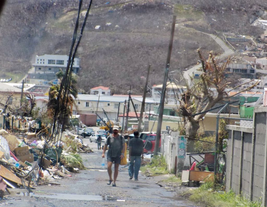 Pedestrians walk through the streets of downtown Philipsburg in St Maarten on Saturday, one week after Hurricane Irma devastated the island.