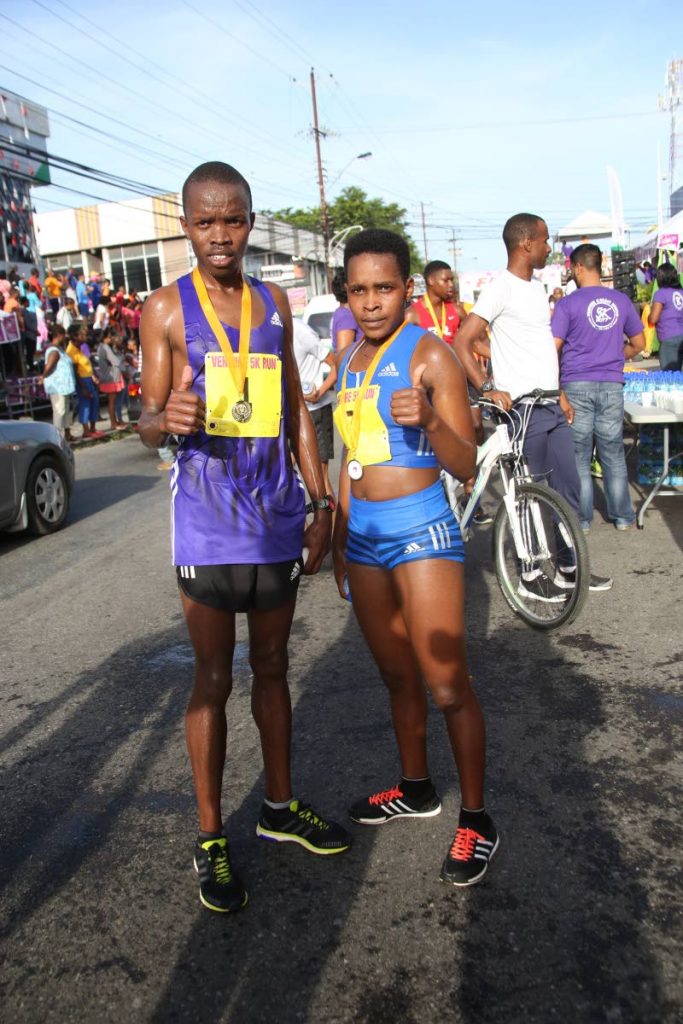 Kenyans Kenneth Rotich (left) and Mercy Chebowgen each give a thumbs-up after winning yesterday's race.