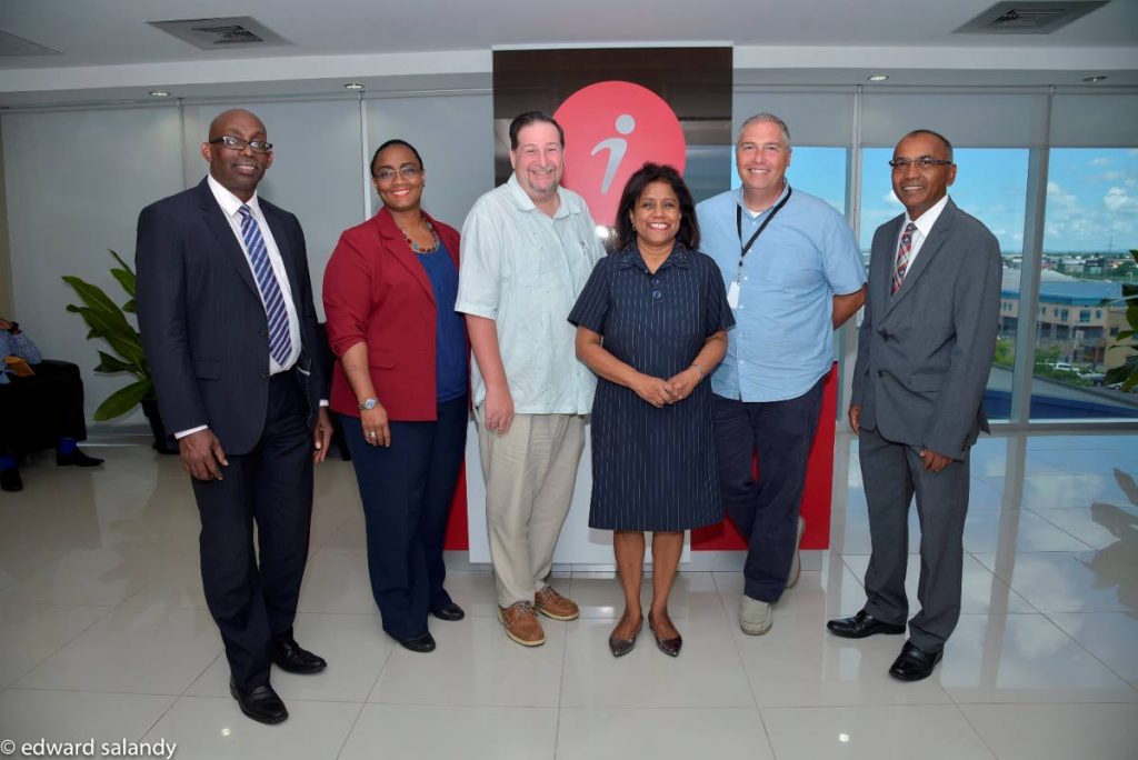 iQor adds 600 jobs to TT:  (Third from left) Trade and Industry Minister, Paula Gopee-Scoon, flanked by John Swain, Director of Operations, iQor (1-800-Flowers), right and Mr. Brian Henderson, Director of Operations, iQor (Metro PCS), left along with Senior Executives, invest Limited. PHOTO COURTESY THE MINISTRY OF TRADE AND INDUSTRY.