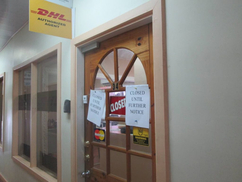 Closed until further notice signs are posted on the door of DHL office in the Charles James Building in downtown following an armed robbery on Tuesday.