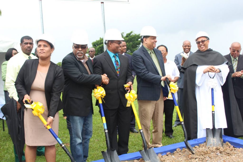 SOD TURNING: Officials from the Holy Cross College in Arima and Arima Mayor Lisa Morris Julien, left, on hand to turn the sod yesterday at the school which will see construction of a new wing to house its Sixth Form as well as an auditorium. 