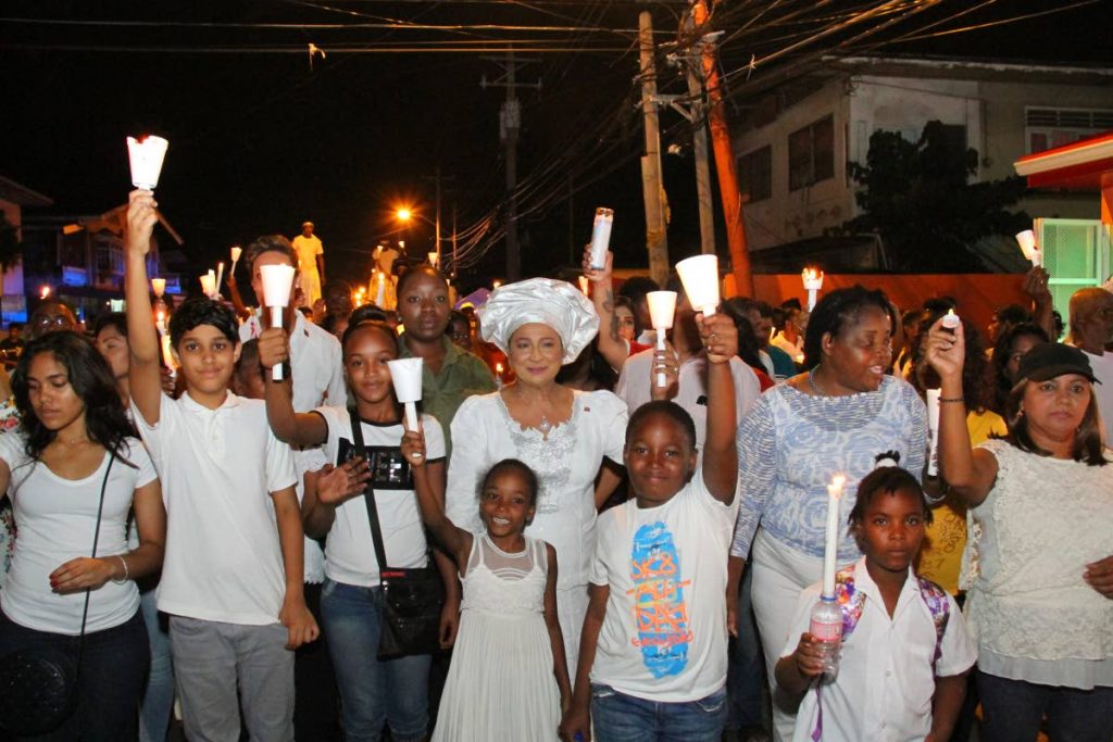Let your light shine: Opposition Leader Kamla Persad-Bissessar joins Building T&T’s candle light anti-crime walk in Aranguez last evening. Photo by Sureash Cholai