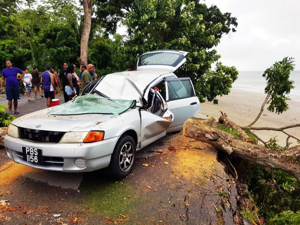 This car was damaged when a tree fell on it during heavy showers and strong gusts yesterday at the Granville beach. Two people were injured.
