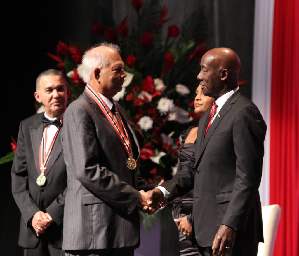 Dr Lenny Saith as he receives the ORTT National Award from Prime Minister Rowley