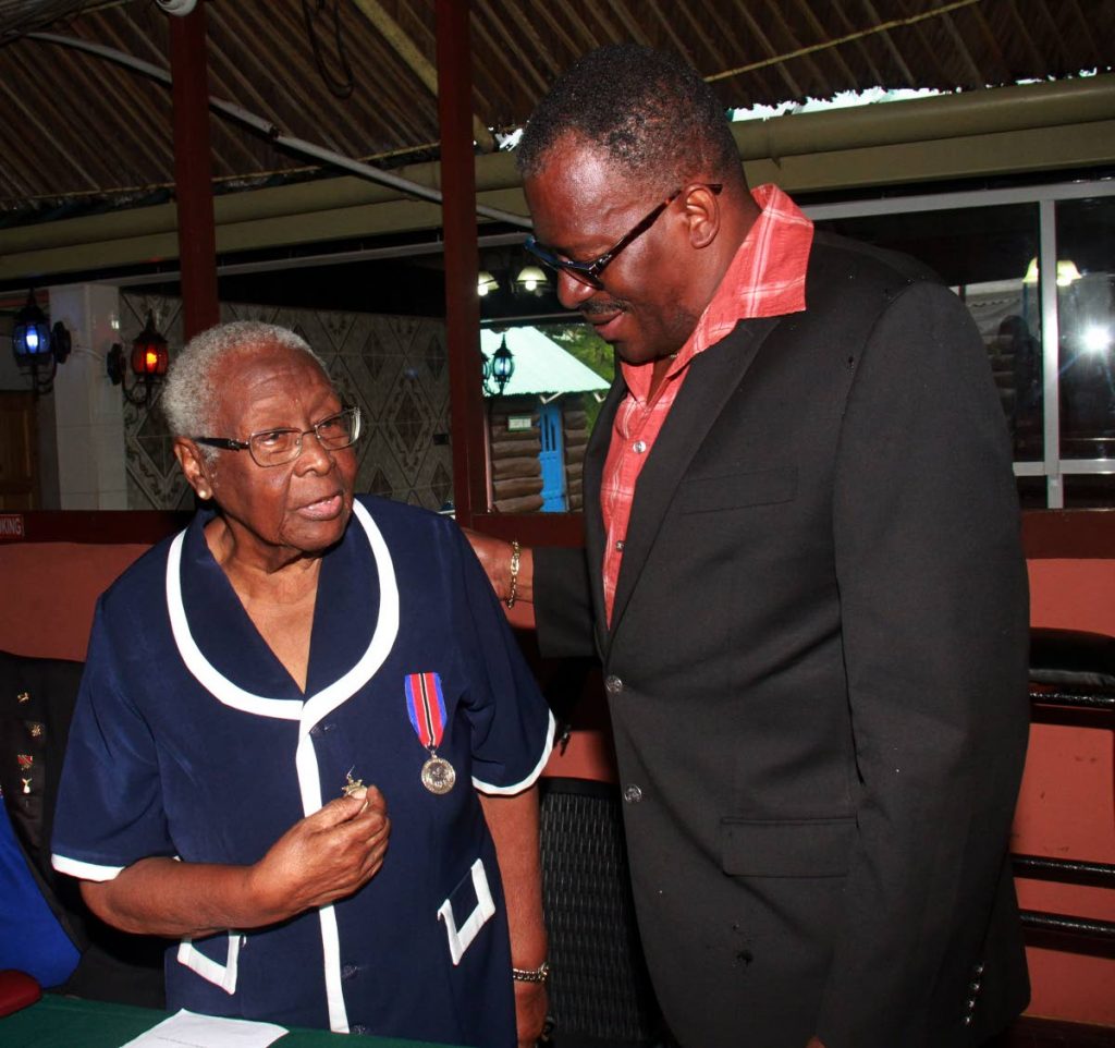 Minister of National Security Edmund Dillon greets World War Veteran Mary Anthony, 91, during a family day of the Southern branch of the Royal Commonwealth Ex-Services League, at Sanderson Heritage Park, Fyzabad.