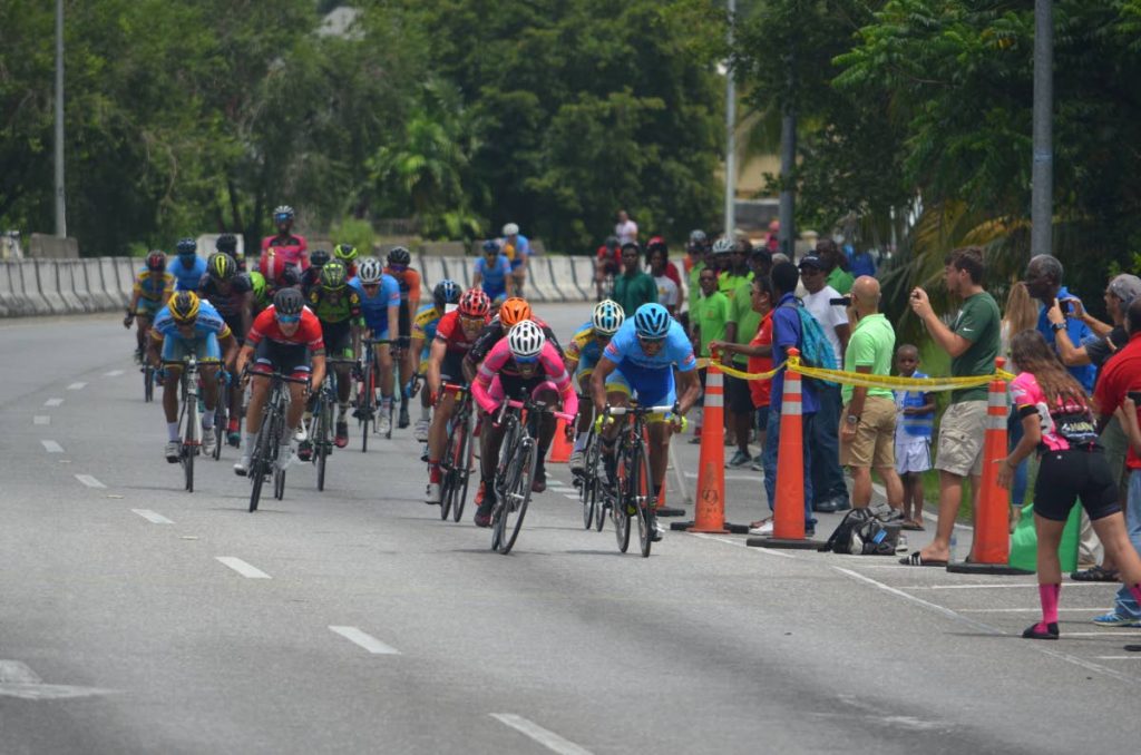 Jamol Eastmond (centre) of Heatwave leads the pack in a sprint to the finish line in the feature race - Invitational Elite 1, 2, 3, at the Republic Day Cycling Classic in Diego Martin on Sunday. PHOTOS COURTESY RONALD DANIEL.
