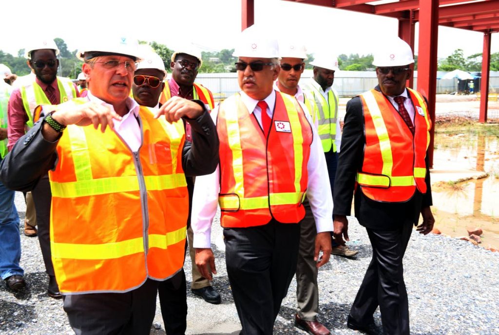 TOUR: Health Minister Terrance Deyalsingh, centre, on a tour yesterday of the site for the new Point Fortin Area Hospital now under construction.