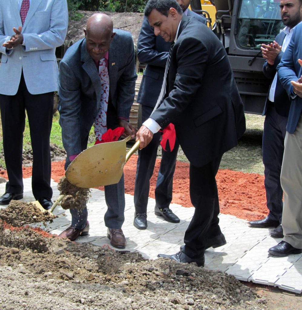 Prime Minister Dr. Keith Rowley and Minister of Works and Transport, Rohan Sinanan turn the sod yesterday to mark the start of construction of the extension of the Churchill-Roosevelt Highway to Manzanilla during a ceremony at the Cumuto Pine Nursery, Cumuto, yesterday while Arvind Kall, Managing Director of Kall Company Limited, the contractor for the project, applauds at right.
PHOTO: VERNE BURNETT