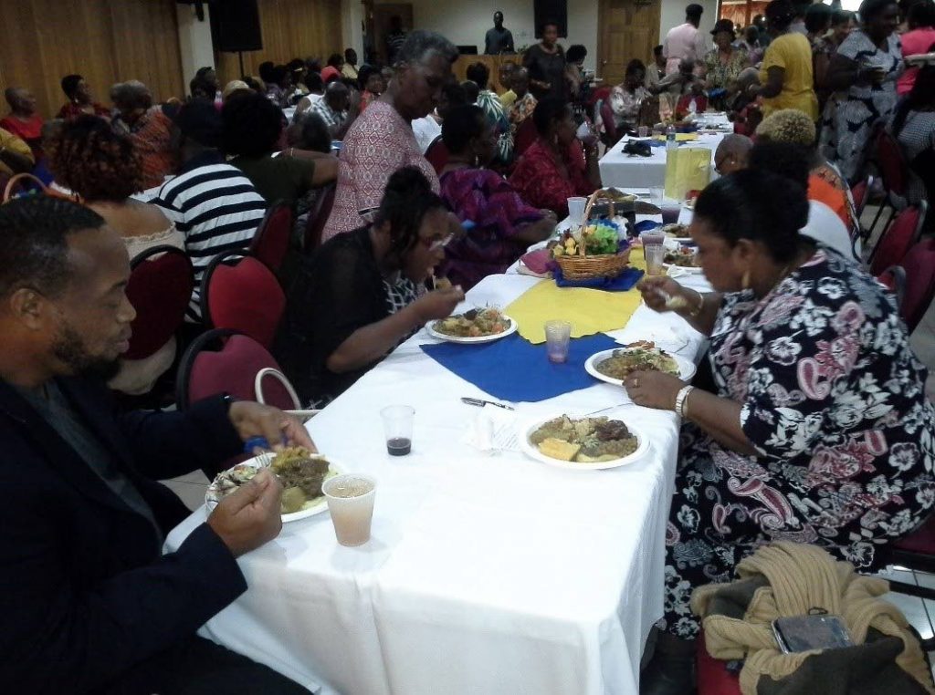 Guests enjoy a meal at the 10th anniversary celebrations of Glenda Roberts-Henrys Soup Kitchen held at the Tobago Nutrition Co-operative Society on September 21.