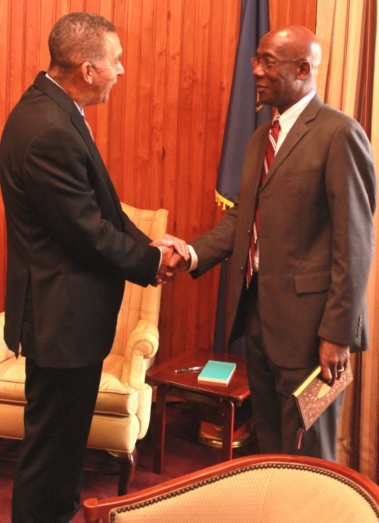 President Anthony Carmona, left, greets Prime Minister Dr Keith Rowley 