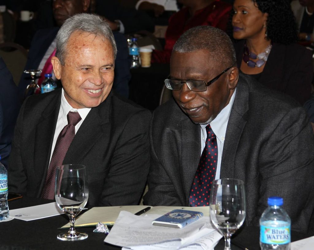 Good advice: Finance Minister Colm Imbert seems pleased with what former Central Bank governor Ewart Williams said to him at last Wednesday’s pre-budget forum at the Hyatt, Port of Spain. Perhaps Williams gave Imbert some last minute advice for tomorrow’s budget presentation. Photo by Rattan Jadoo