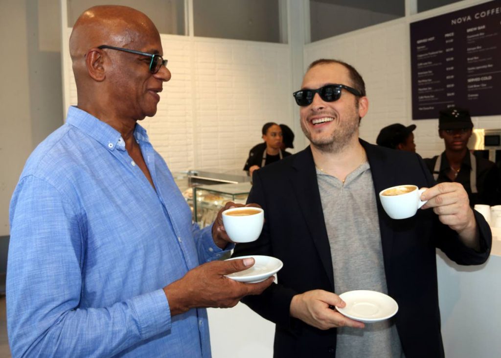 Have a cuppa’: San Fernando Junia Regrello enjoys a cup of Nova Coffee with Gerald Aboud at the opening of Aboud’s coffee shop at South Park, San Fernando yesterday. Photo by Ansel Jebodh