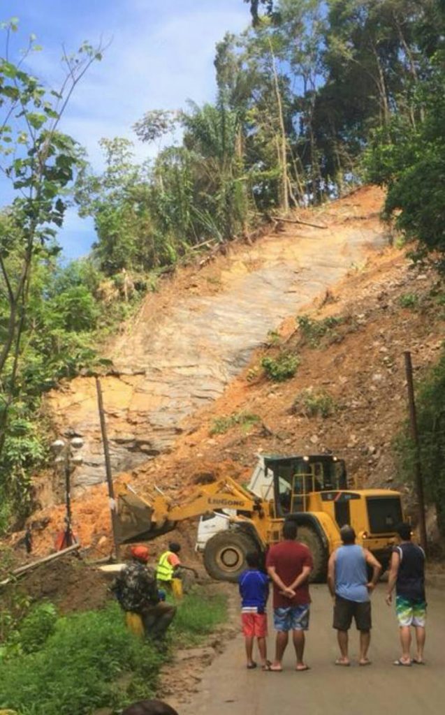 Heavy machinery clear the landslide along the North Coast Road which temporarily blocked access to the Maracas Lookout yesterday. 