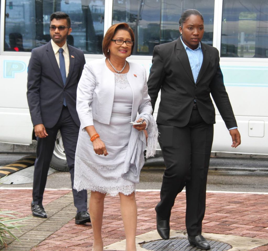 Opposition Leader Kamla Persad-Bissessar, centre, makes her way to Parliament yesterday for the 2018 Budget presented by Finance Minister Colm Imbert.