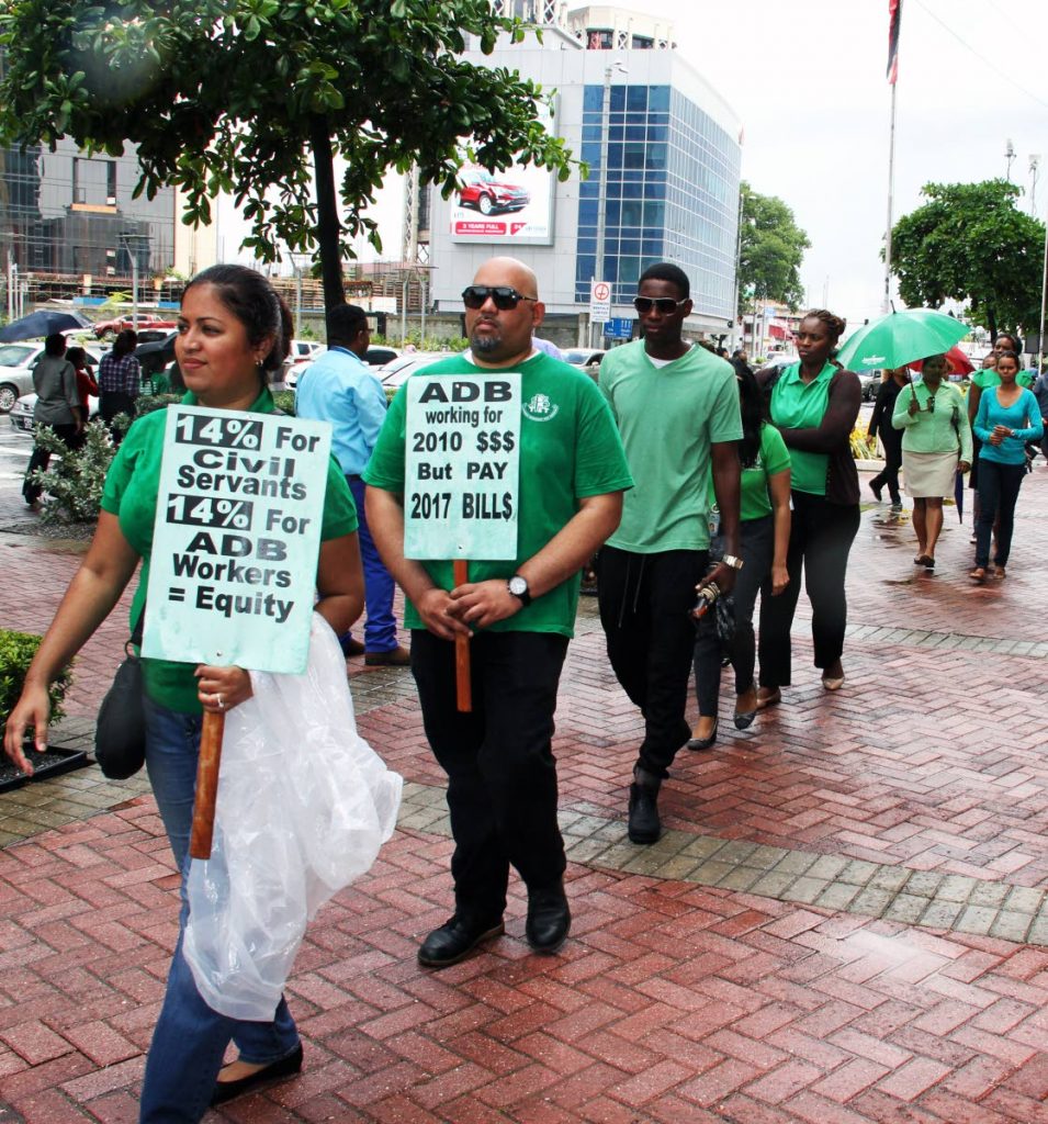 BUDGET DAY PROTEST: While Finance Minister Colm Imbert was in Parliament delivering the 2018 National Budget, members of Public Services Association (PSA) engaged in a protest march outside the Parliament Tower in Port of Spain yesterday. 