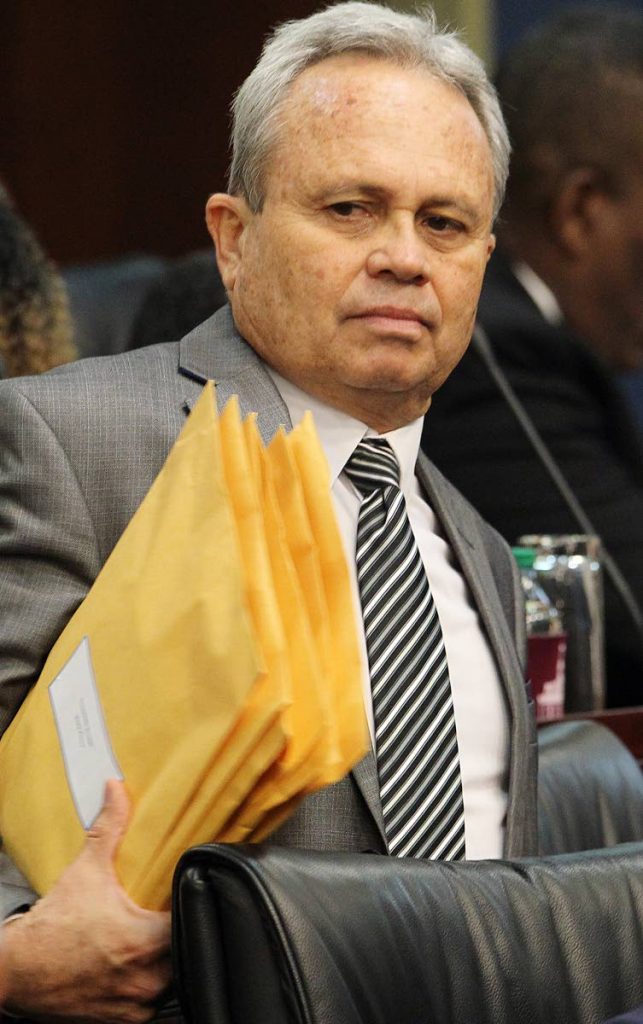 Serious business: Finance Minister Colm Imbert with documents in hand before presenting the 2018 budget yesterday. 
Photo by Rattan Jadoo