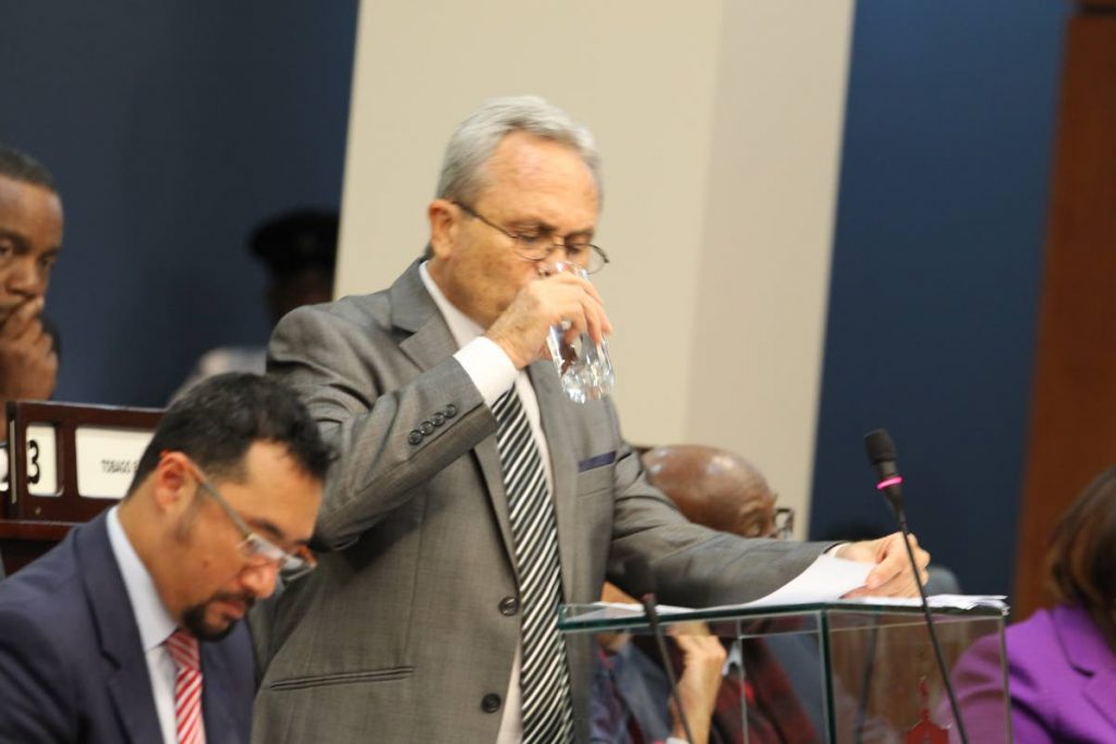 I’LL DRINK TO THAT: Finance Minister Colm Imbert quenches his thirst during his 2018 Budget presentation in the House yesterday.