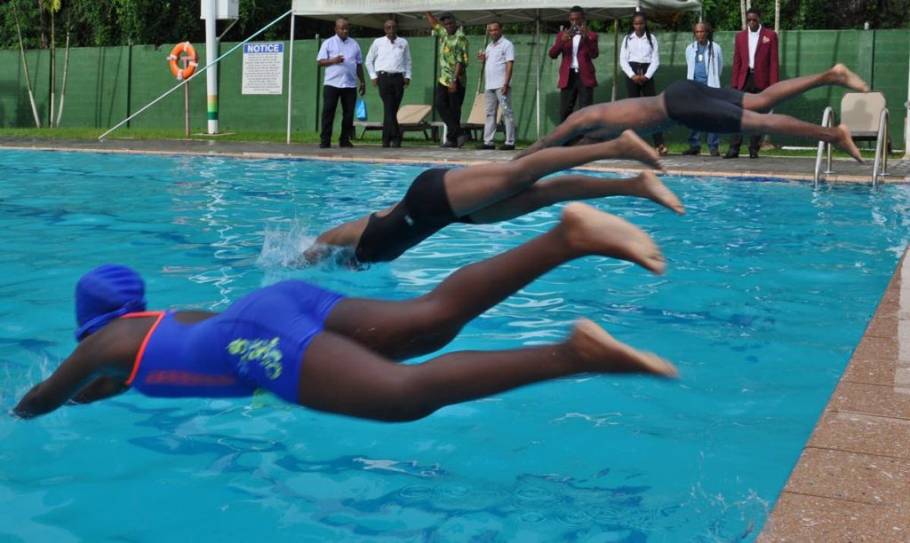 Members of the All Mayaro Sports Foundation, including the group’s Chairman, Bartholomew ‘Bunny’ Lynch (second from left), observe young swimming talent in actions at the BPTT Mayaro Resource Centre pool.