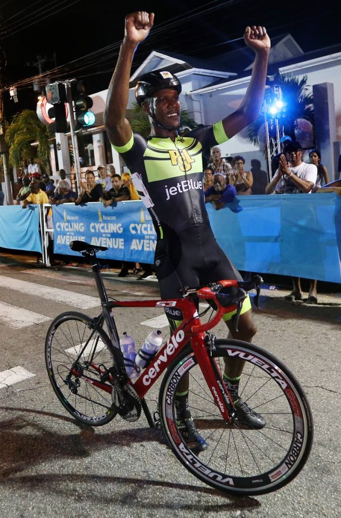 Jamaican Marloe Rodman raises his hands in 
triumph after winning the main event at the 
Beacon Cycling on the Avenue on Wednesday night at Ariapita Avenue, Port of Spain. PHOTO BY AZLAN MOHAMMED