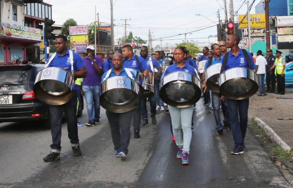 The Defence Force Steel Orchestra plays Amazing Grace for the Edinburgh 500 Police Youth Club’s anti-crime march in Chaguanas yesterday.