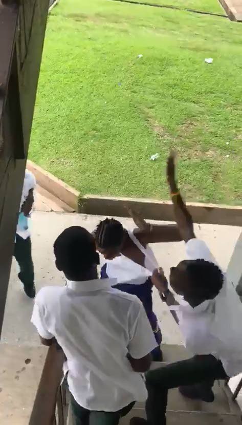 FLASHBACK: A student fires a slap while holding on to the vest of another student at the Siparia West Secondary School last week.