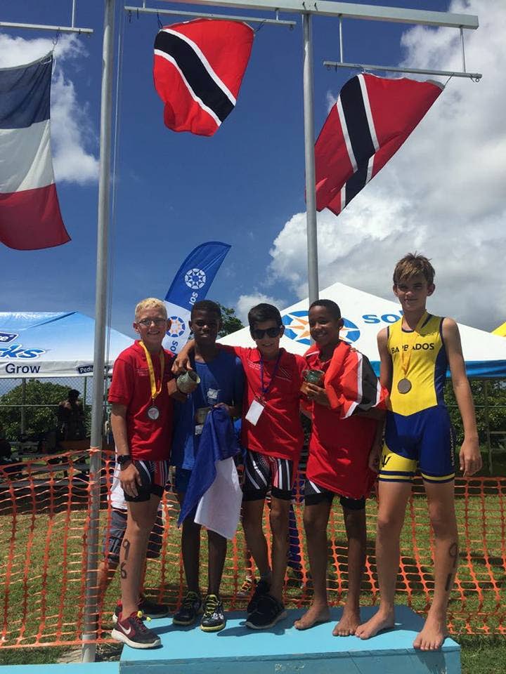 Luke Ferreira of Trinidad and Tobago, centre, after winning the boys 11 to 12 boys triathlon at the Carifta Triathlon and Aquathlon Championhips in Barbados, yesterday. Bronze medallist Justin Boynes of TT is second from right and Daniel Shaw of TT, left, finished fourth. 